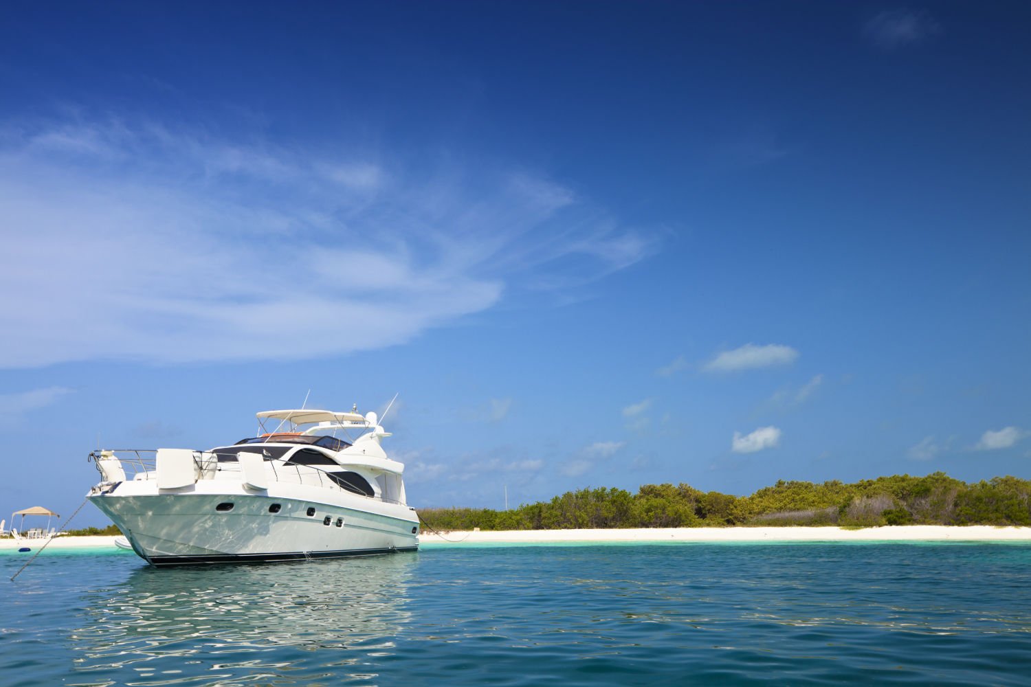 Luxury Yachts anchored in a tropical exotic island beach